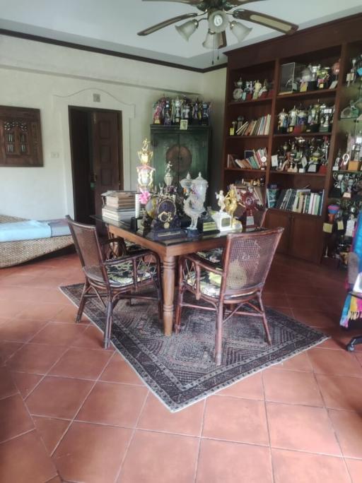 Cozy dining area with wooden furniture and decorative shelf