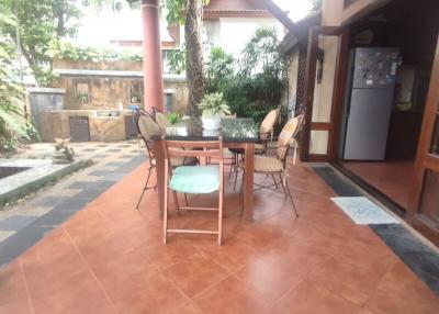 Spacious covered patio with dining set and tiled flooring