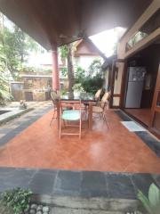 Spacious covered patio with dining set and tiled flooring