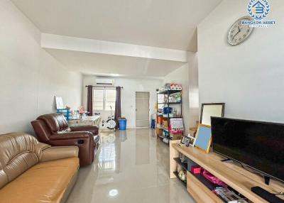 Spacious and bright living room with leather sofa and glossy floor tiles