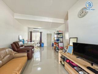 Spacious and bright living room with leather sofa and glossy floor tiles