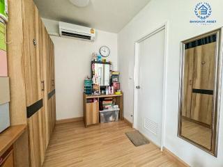 Cozy bedroom interior with wooden furniture and air-conditioning