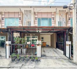 Townhouse front view with parking space and balcony