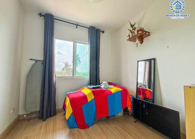 Cozy bedroom with natural light and wooden flooring