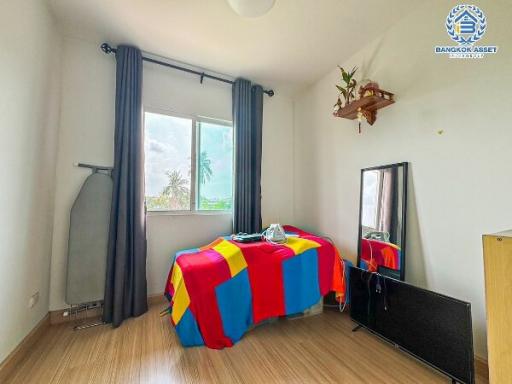 Cozy bedroom with natural light and wooden flooring