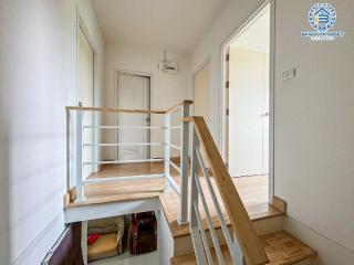 Wooden staircase in a well-lit modern home interior