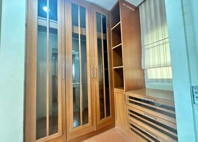 Spacious bedroom with large built-in wardrobe and drawers