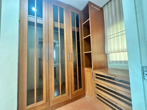 Spacious bedroom with large built-in wardrobe and drawers