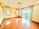 Spacious and well-lit bedroom with a balcony