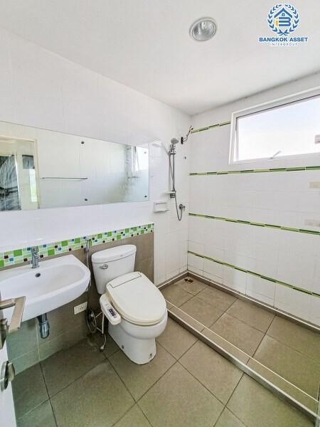 Bright bathroom with modern amenities and safety handrails