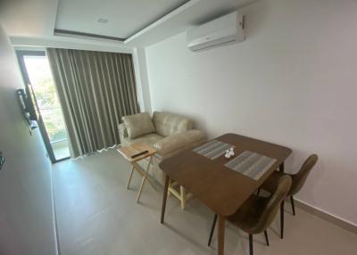 Modern living room with dining area and natural light