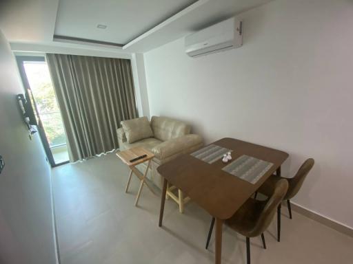 Modern living room with dining area and natural light