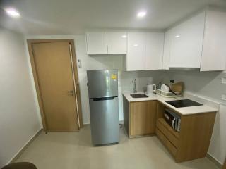 Modern kitchen with wooden cabinets and stainless steel appliances