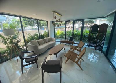 Spacious and well-lit living room with modern furniture and garden view