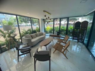 Spacious and well-lit living room with modern furniture and garden view