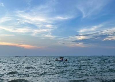 Peaceful ocean view with a boat at sunset