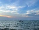 Peaceful ocean view with a boat at sunset