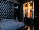 Luxurious dark-toned bedroom with tufted headboard and elegant lighting