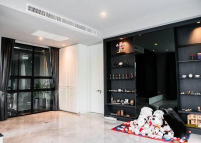 Modern living room with plush toys and a home bar