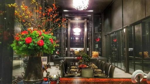 Elegant living room with modern decor and vibrant flower arrangements