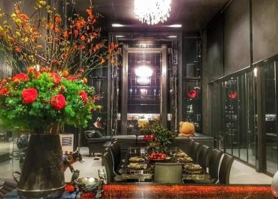 Elegant living room with modern decor and vibrant flower arrangements