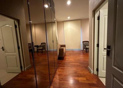 Spacious Bedroom with Mirrored Wardrobe Doors and Hardwood Flooring