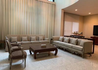 Spacious and elegant living room with modern furniture and ample natural light