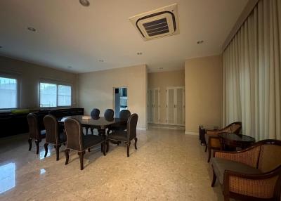 Spacious living room with dining area and marble flooring