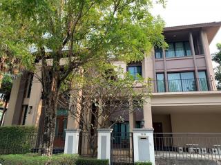 Front view of a two-story residential house with trees