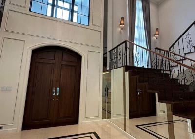 Elegant entrance foyer with high ceiling and chandelier