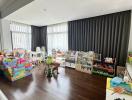 Spacious living room with children's play area and floor-to-ceiling windows