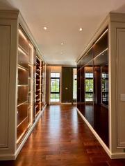 Elegant corridor with built-in wooden shelves and hardwood flooring