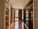 Elegant corridor with built-in wooden shelves and hardwood flooring