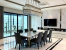 Modern dining room with an elegant table, designer chairs, and a stylish chandelier