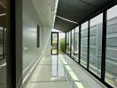 Bright and modern hallway with large windows and a view to the exterior