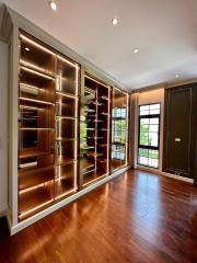 Spacious living room with wooden flooring and built-in shelves