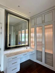 Elegant bathroom with large mirror and marble countertop