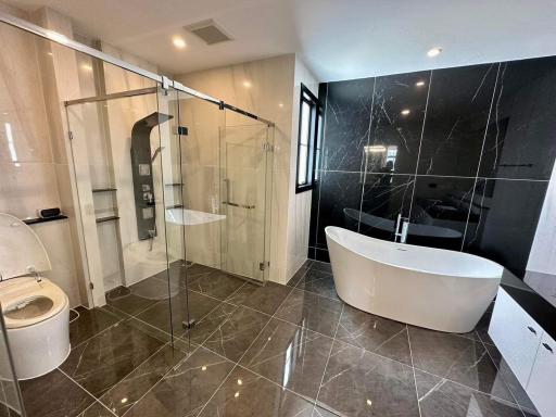 Modern bathroom with glass shower and freestanding bathtub