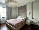 Elegant bedroom with a large bed and modern chandelier