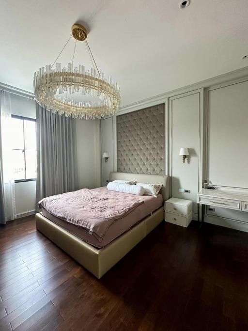 Elegant bedroom with a large bed and modern chandelier