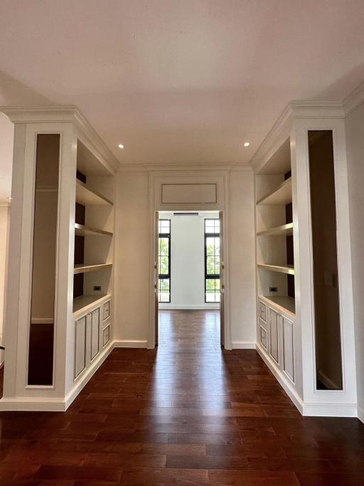 Bright and airy living space with built-in shelves and hardwood flooring