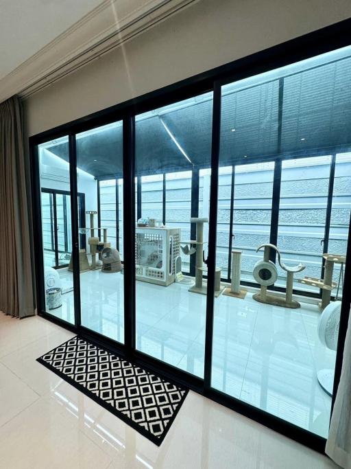 Home gym with exercise equipment and large windows