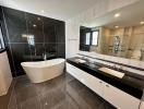 Modern bathroom with freestanding tub, double vanity, and large mirror