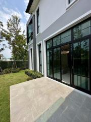 Modern two-story house with large windows and backyard