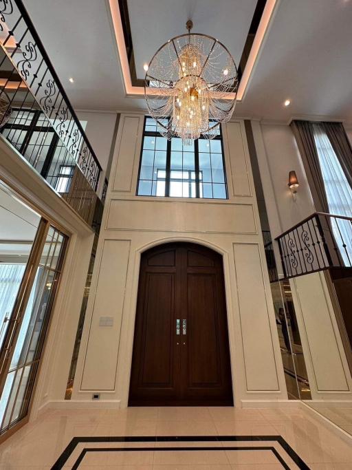 Elegant entrance hall with high ceiling and grand chandelier