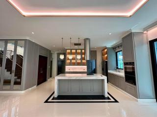 Modern kitchen with central island and LED lighting