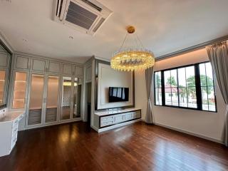 Spacious living room with large windows and elegant chandelier