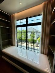 Cozy bedroom with a large window and built-in seating area