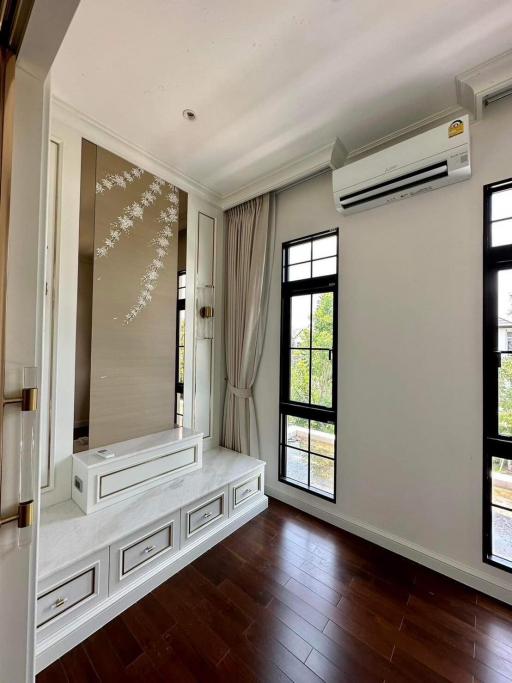 Bright and elegant bedroom with floor-to-ceiling windows and hardwood flooring