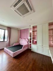Elegant bedroom with large windows and a pink velvet bed